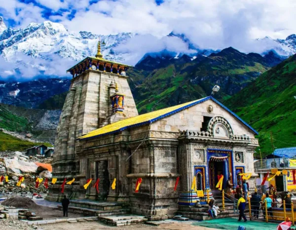 a stone building with a steeple and a steeple with Kedarnath Temple in the background,Kedarnath Temple